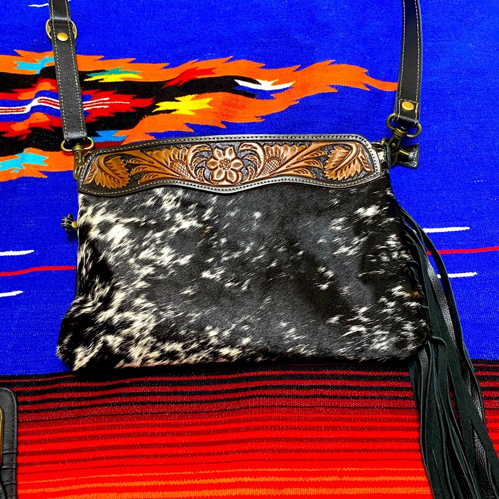 Myra black and white cowhide purse with brown tooled accents.